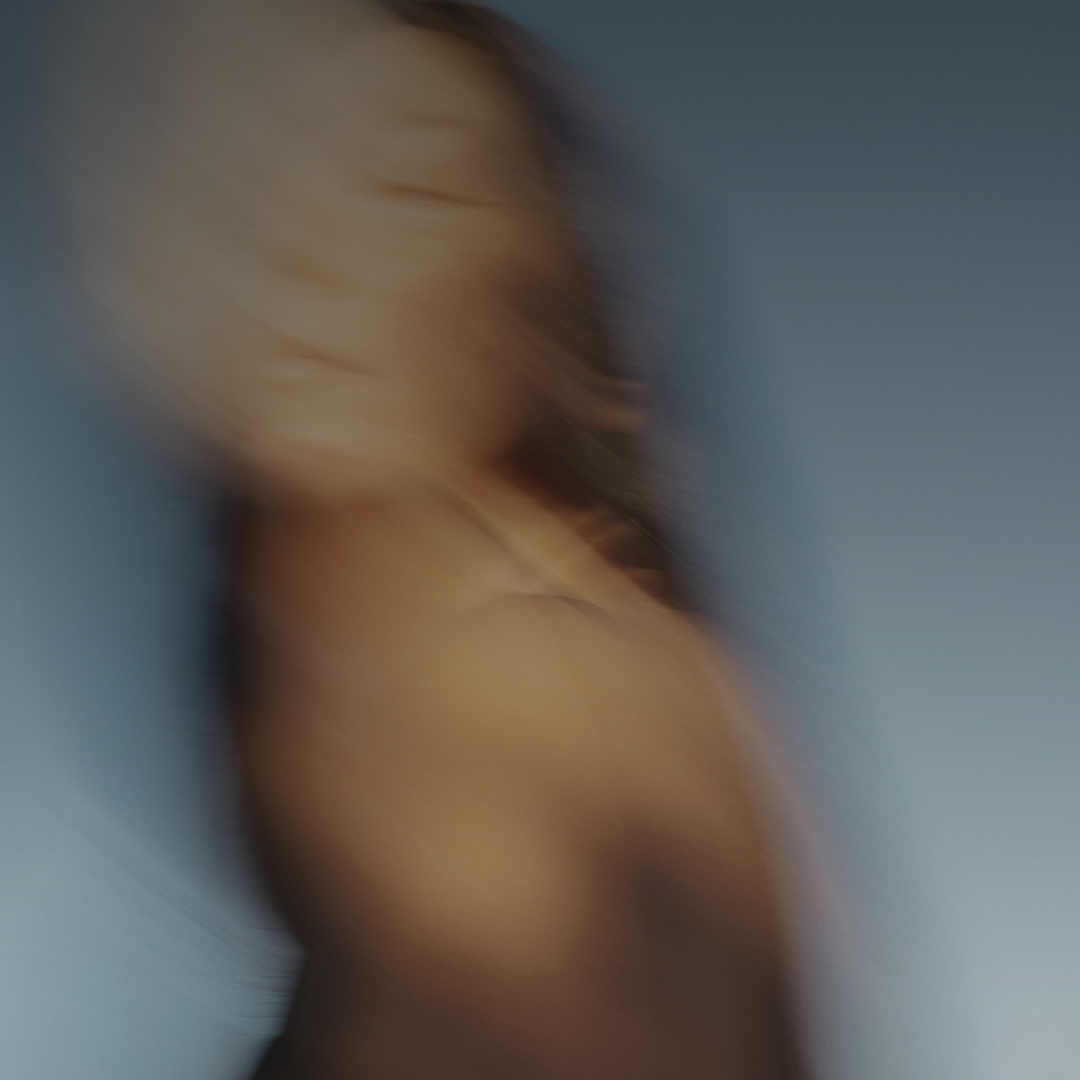 Blurred image of a person with a neutral expression on a plain background